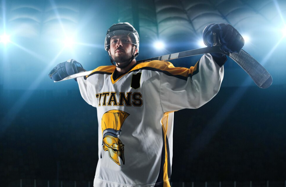 ice hockey players with hockey stick and lights above him