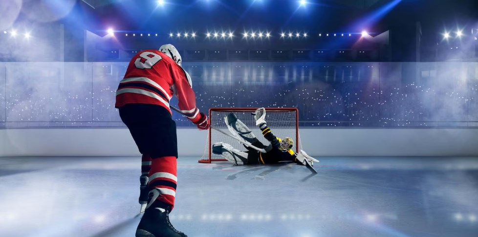 a hockey goaltender catching a puck on a skating arena